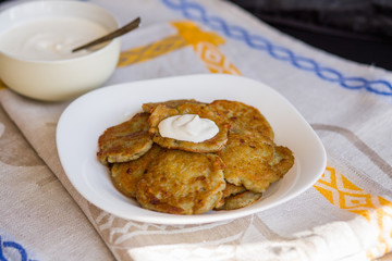 Potato pancakes with sour cream. National Russian dish.