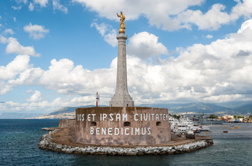Golden statue of the "Madonna della Lettera" on an obelisk at the entrance of the harbor of Messina (Sicily)