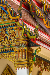 Fototapeta premium Traditional Thai temple front details. Wat Mongkol Nimit temple in Phuket town, southern Thailand.
