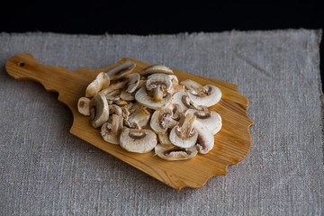 Mushrooms mushrooms raw sliced slices on a wooden Boards