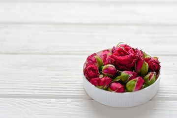 Flowers composition. Pink roses on white wooden background