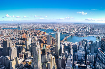 Skyline aerial view of Manhattan with skyscrapers, East River, Brooklyn Bridge and Manhattan Bridge...