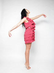 Fototapeta premium Jumping woman. Happy emotional girl wearing pink dress. 
