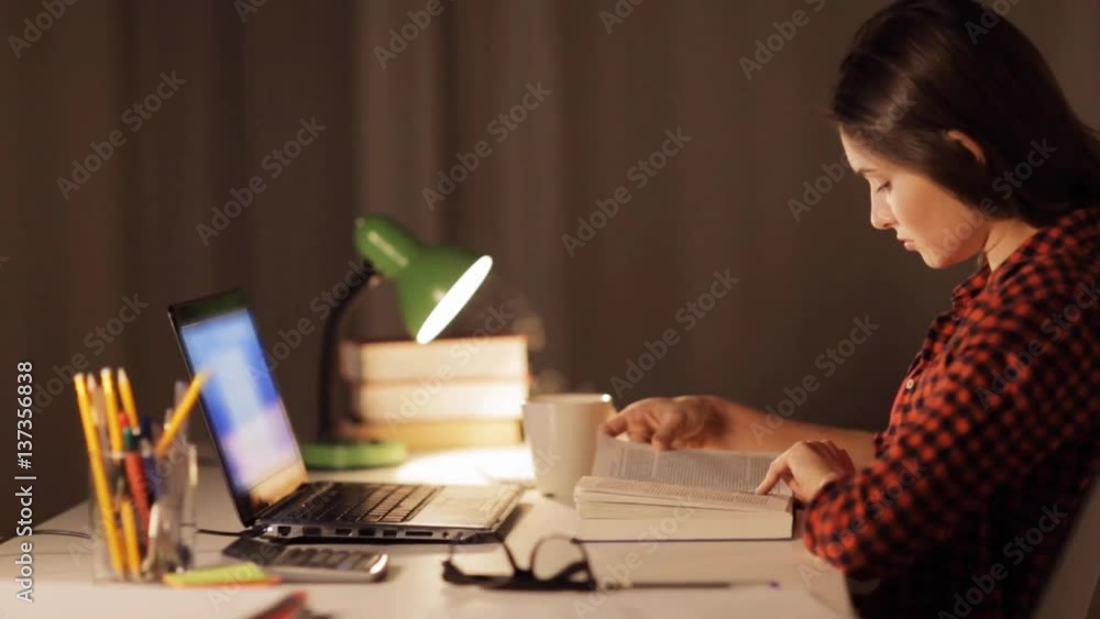 Wall mural student girl or woman reading book at night home