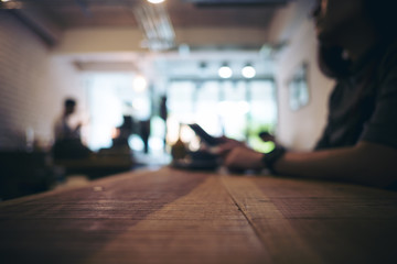 Wooden table in cafe with blur bokeh vintage backgroud