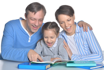 parents with daughter reading books