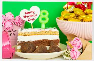 dessert and chocolate candies on a plate with a candle 8, none in shape of heart for text, a bouquet of flowers in a bucket. greeting card Happy Women's Day on eight march  