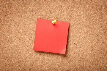 Red blank sticky note on corkboard