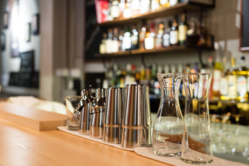 Cocktail mixing utensils on bar counter, selective focus