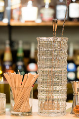 Cocktail mixing utensils on bar counter, selective focus