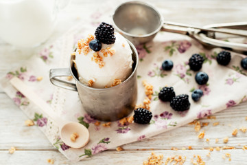 dessert , white ice cream with berries , blackberries and blueberries , milk on the wooden background 