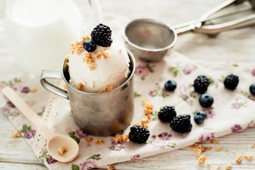 dessert , white ice cream with berries , blackberries and blueberries , milk on the wooden background 