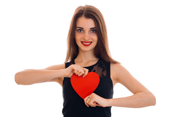 Happy young brunette girl posing with red heart isolated on white background. Saint Valentines Day concept. Love concept.