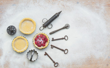 Rural kitchen utensils on wooden table from above - rustic background with free text space vintage style