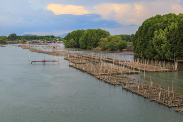 Fototapeta na wymiar Fish farm with coop in long river, Thailand