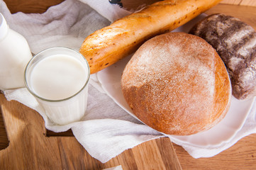 Top view assortment of breads and glass of milk . Selective focus