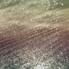 Abstract of Bright and sparkling bokeh background. golden bokeh-blurred lighting from glitter texture. Luxury design background.