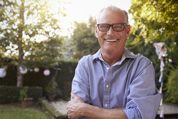 Fototapeta premium Portrait Of Mature Man In Back Yard Garden
