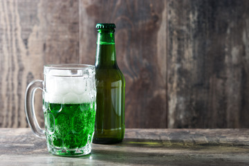 Traditional cold green beer on wooden table for Saint Patrick's Day. Copyspace.