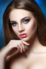 Beauty portrait of a beautiful girl with a bright evening make-up in blue.