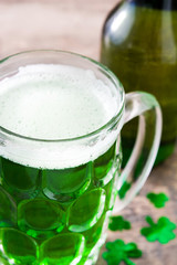 Traditional cold green beer on wooden table for Saint Patrick's Day. Copyspace.