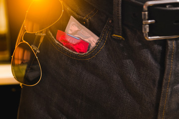Condoms in package in jeans. Protection against AIDS. Safe sex concept. contraception and birth...