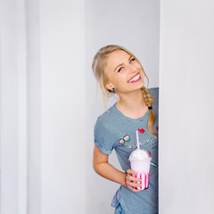 Young beautiful blonde girl walking through the city streets