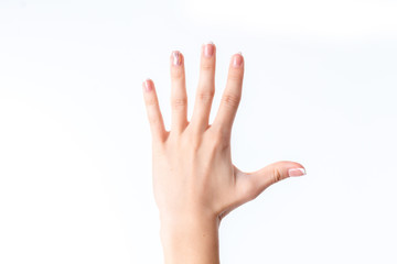 female hand showing the gesture with five fingers is isolated on a white background