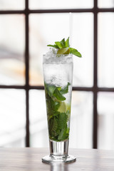 Mojito cocktail in a restaurant on a rustic wooden table