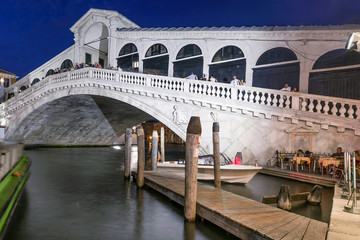 Fototapeta na wymiar Superb view of the famous Rialto Bridge, Venice, Italy, illuminated by the light of the blue hour after sunset