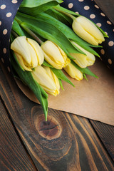Yellow tulips in polka dot kraft envelope
