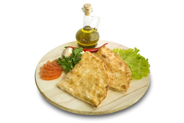 pieces of pizza calzone on wooden cutting board

