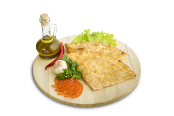 pieces of pizza calzone on wooden cutting board
