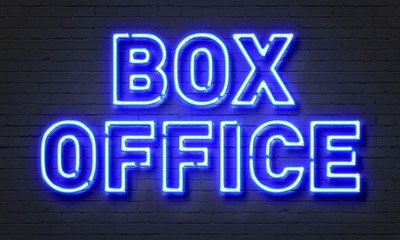 Box office neon sign on brick wall background.