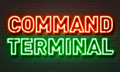 Command terminal neon sign on brick wall background.