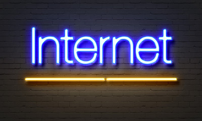 Internet neon sign on brick wall background.