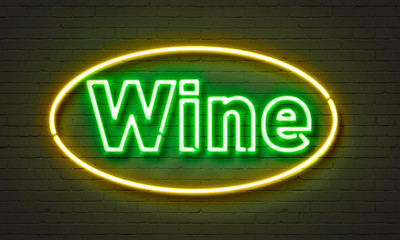 Wine neon sign on brick wall background.