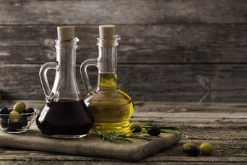 Obraz na płótnie Canvas olive oil and balsamic vinegar on a wooden background