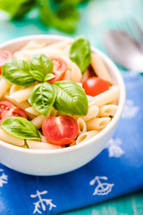 plate of penne pasta with tomato