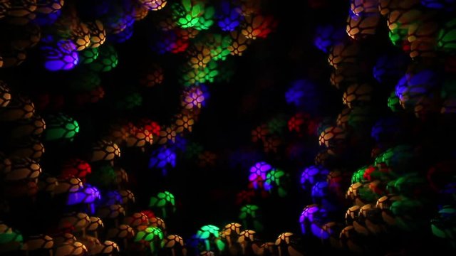 Abstract holiday background of blinking lights with complex web pattern like soccer ball. Twinkling and slightly weaving multicolor decoration. Celebration flashing colorful specks on night backdrop