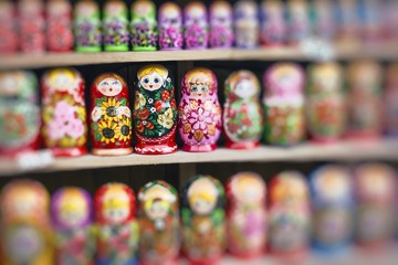 Fototapeta na wymiar Colorful Russian nesting dolls matreshka at the market. Matrioshka Nesting dolls are the most popular souvenirs from Russia.