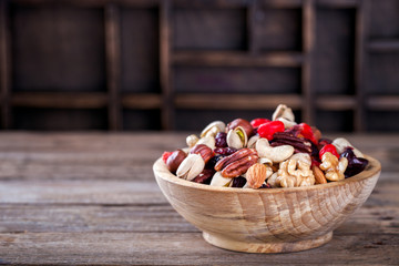 Fototapeta na wymiar Nuts and dried fruit mix. Concept of Healthy Food. Vintage wooden background. Copy space for Text.Copy space. selective focus