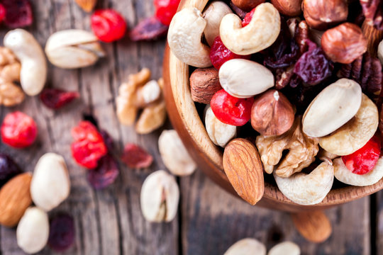 Nuts and dried fruit mix. Concept of Healthy Food. Vintage wooden background. Copy space for Text.Copy space. selective focus