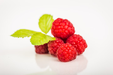 Ripe red raspberries isolated on white background
