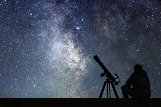 Man with astronomy  telescope looking at the stars.