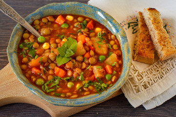 Vegetarian  lentil stew with bolognese sauce  in a bowl with parsley on rustic wooden table. Top view.