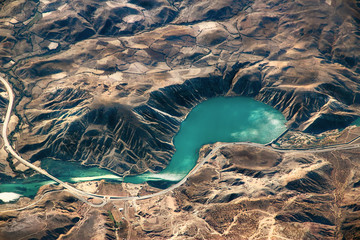 Complex of mountains and dam seen from the air.