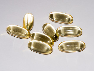 Tabs Vitamins, omega 3, Medications tablets and capsules in a beaker. Medications tablets,...
