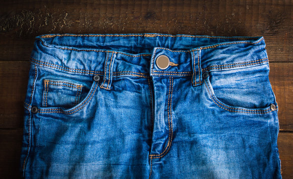 Jeans on a wooden background