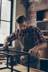  handsome  craftsman work with ruler. Stylish young worker with brutal hairstyle and saved glasses...